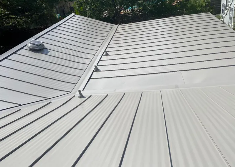 Solar attic fan installed on a metal roof for Roof Ventilation in Cohasset